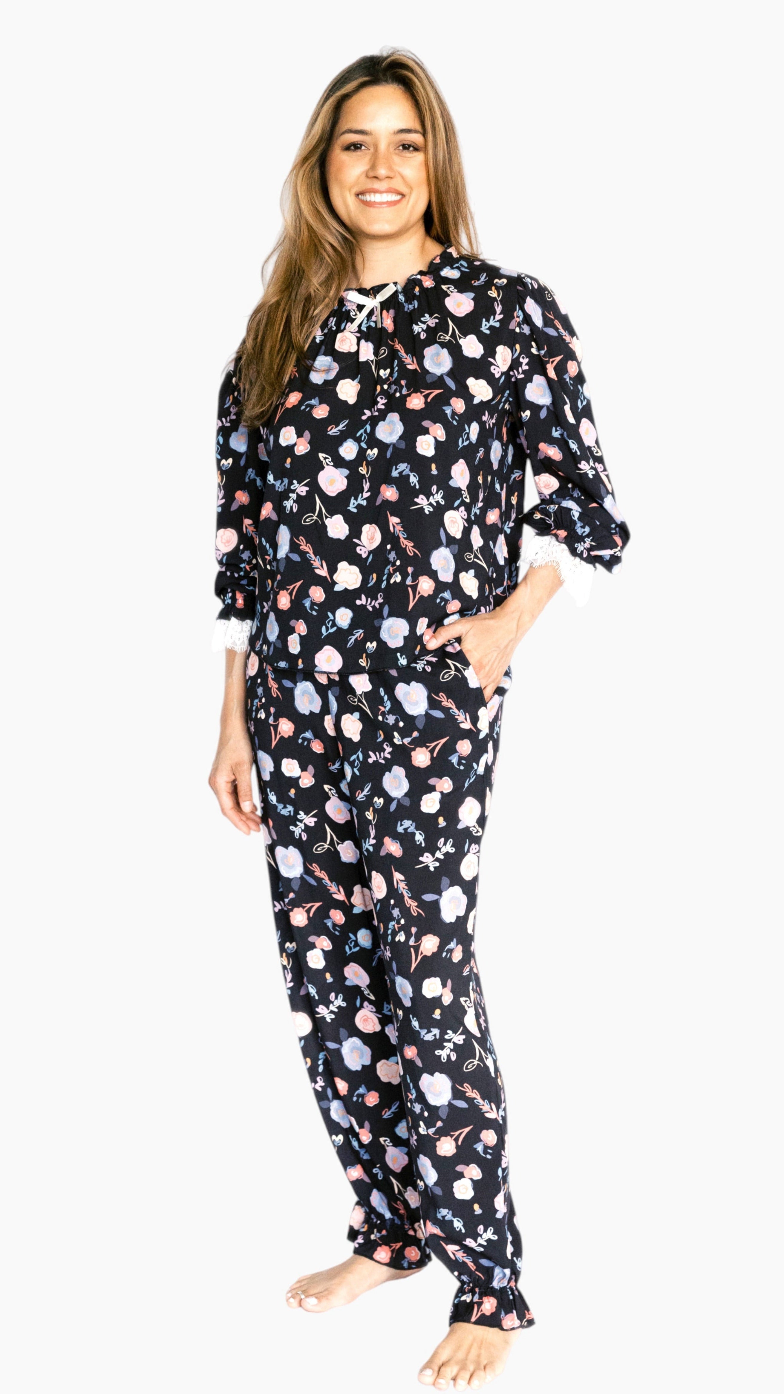 Woman wearing a floral pajama set on a white background