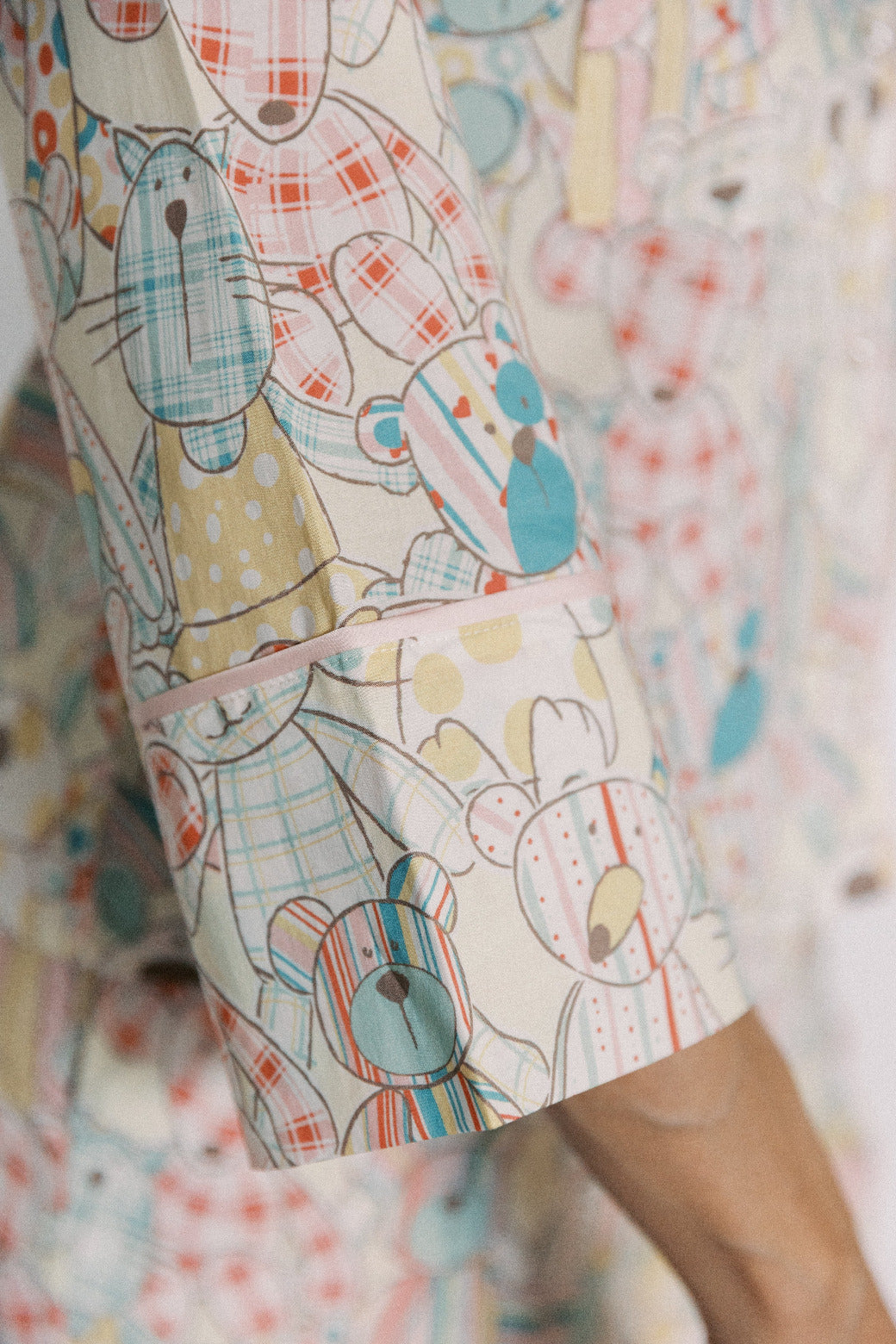 Close-up of a fabric with colorful bear pattern on a blurred background