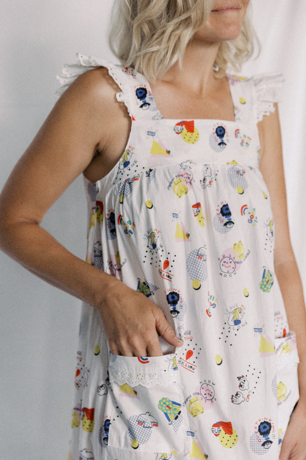 White sleeveless nightdress with colorful cartoon character print on a plain background