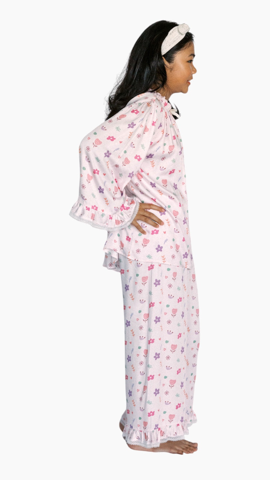 Woman wearing a floral nightgown on a white background