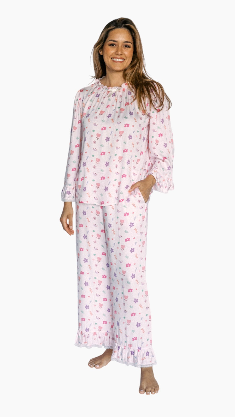 Woman wearing a pink floral pajama set on a white background
