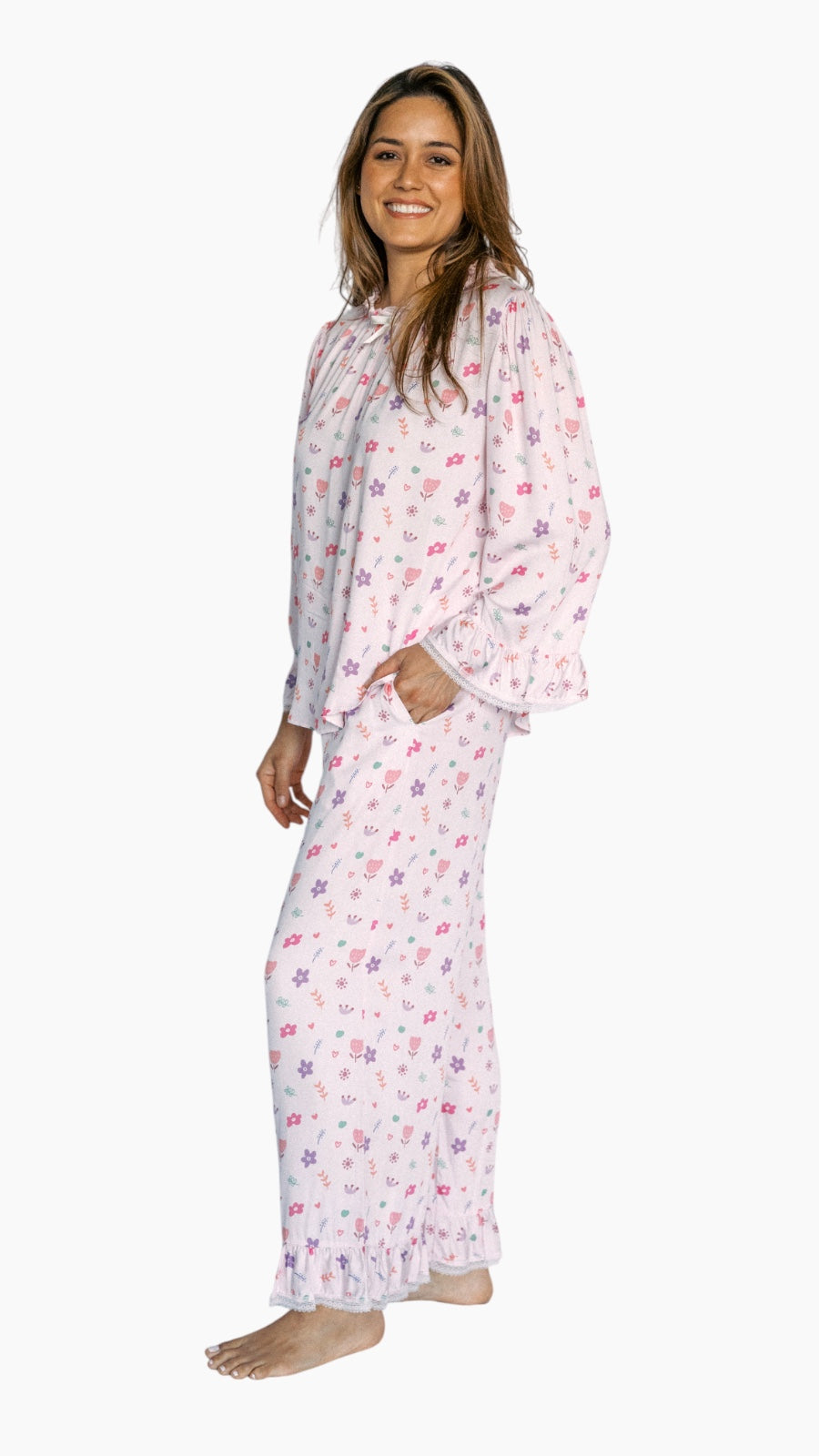 Woman wearing a floral pajama set on a white background