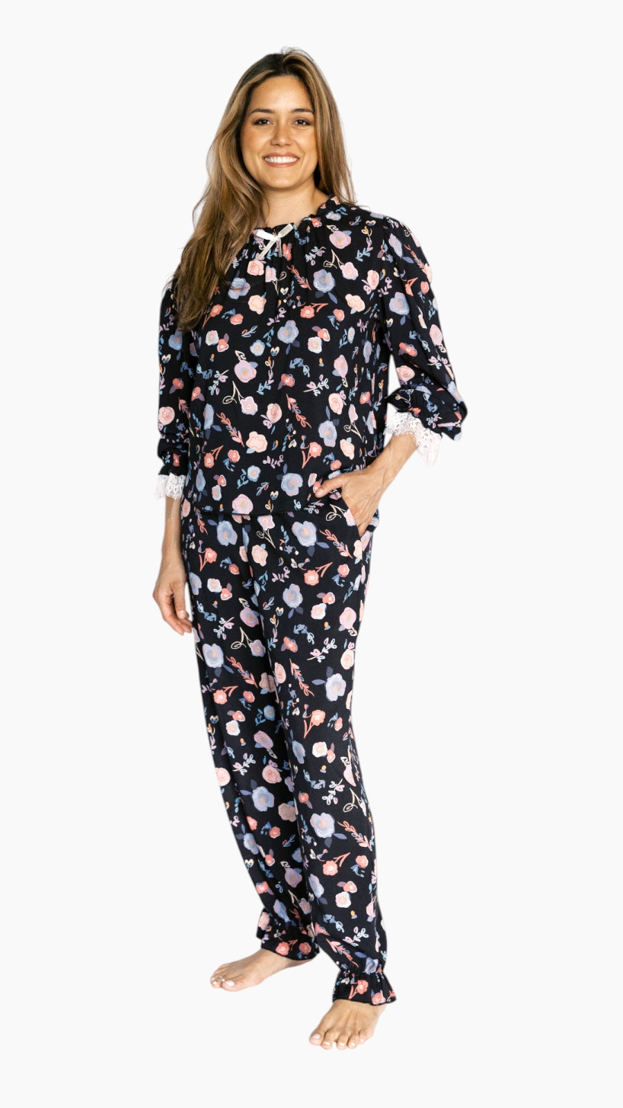 Woman wearing a floral pajama set on a white background