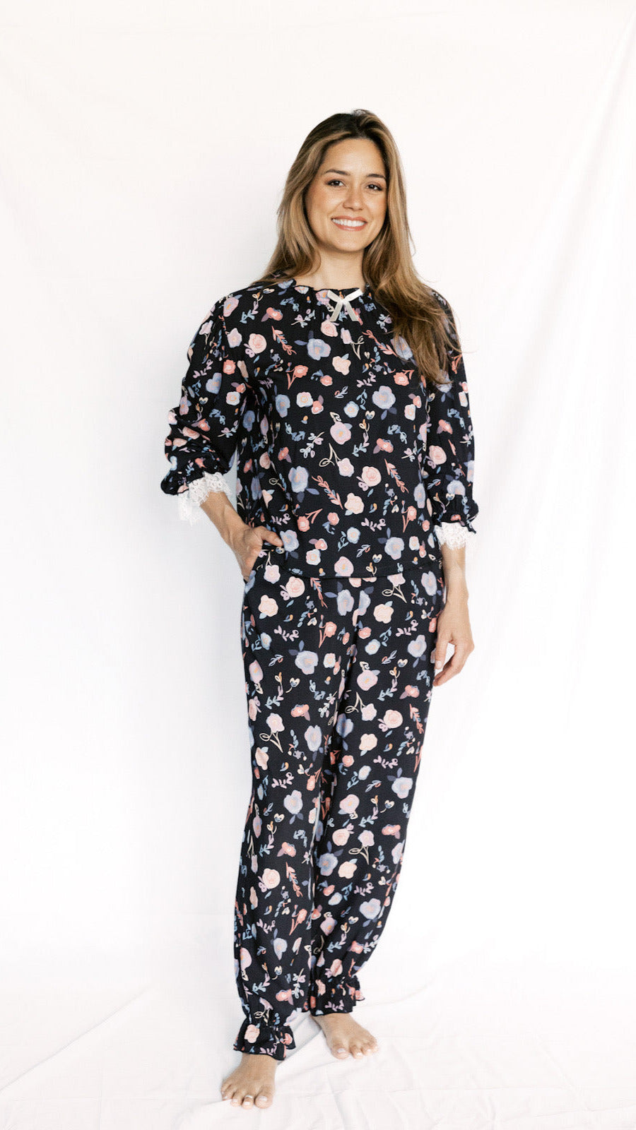 Woman wearing a floral pajama set on a white background