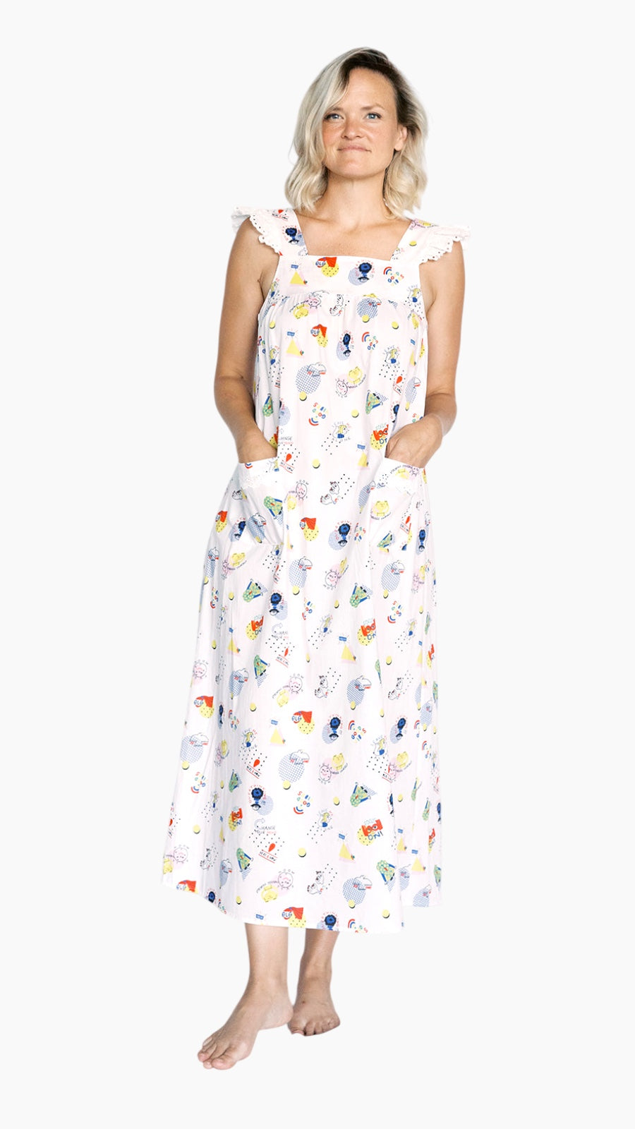 Woman wearing a long, good vibes print nightgown on a white background