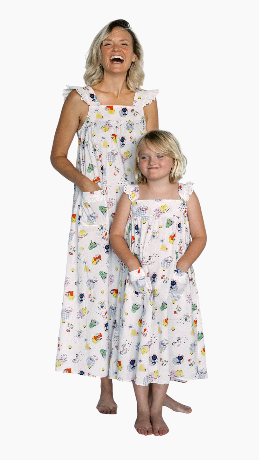 Woman and child wearing matching floral dresses on a white background