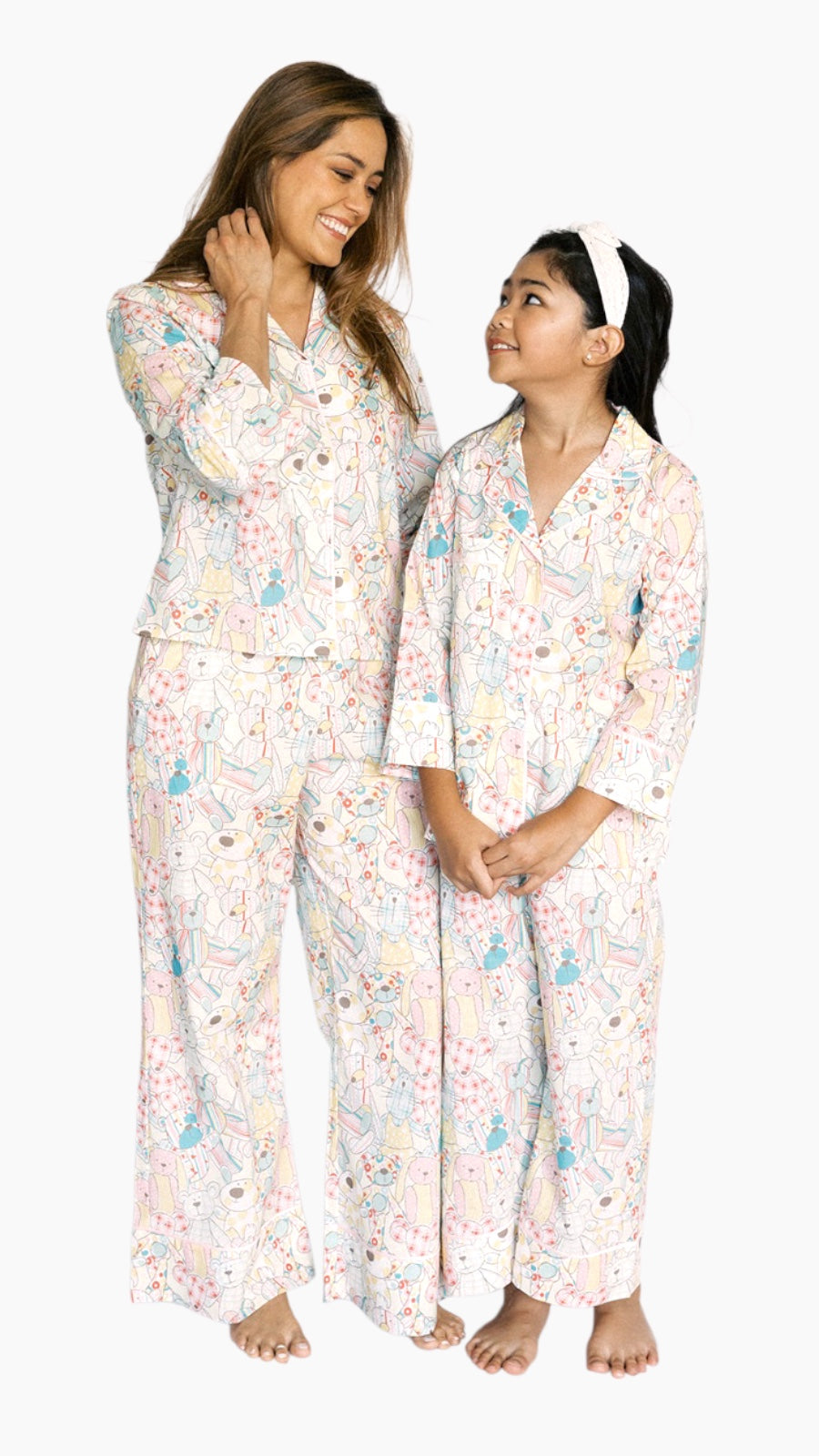 Woman and child wearing matching pajama sets with a floral pattern on a white background