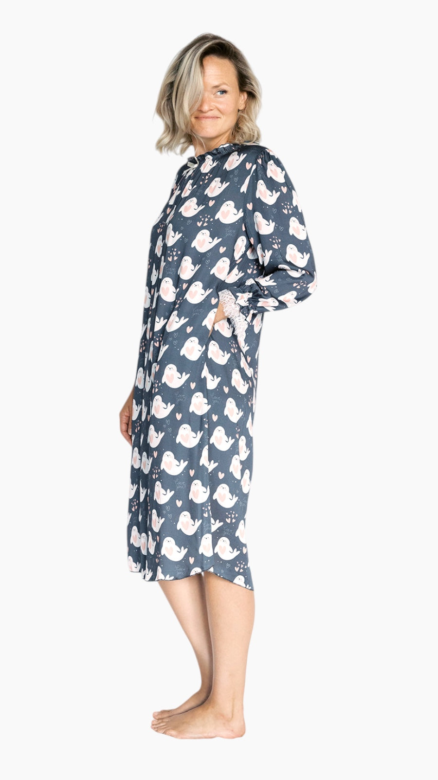 Woman wearing a blue nightgown with seal love pattern on a white background